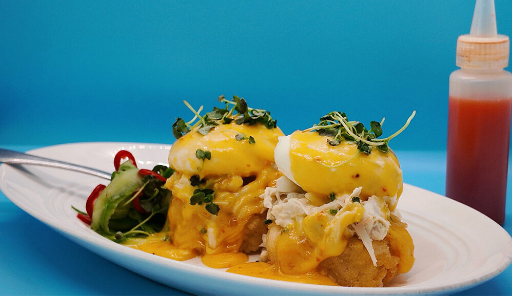 Photo of Blue Crab Eggs Benedict with Crispy Rice, Yuzu Kosho Hollandaise, Pickled Fresno, Cucumber Herb Salad
