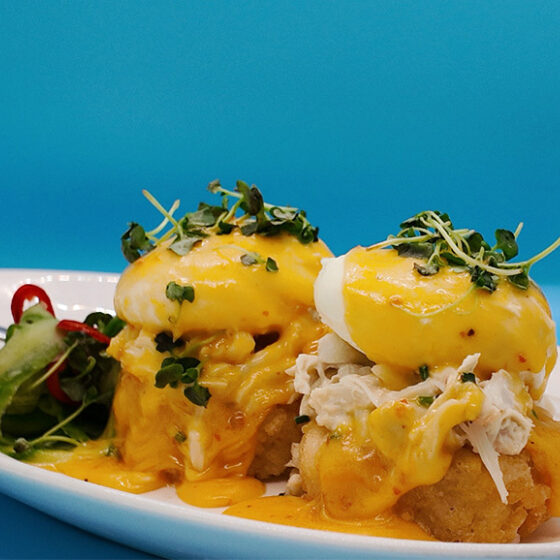 Photo of Blue Crab Eggs Benedict with Crispy Rice, Yuzu Kosho Hollandaise, Pickled Fresno, Cucumber Herb Salad
